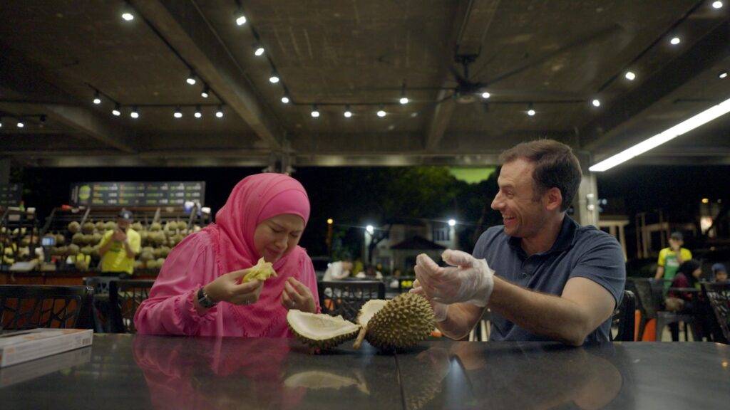 a man and woman preparing food in a restaurant